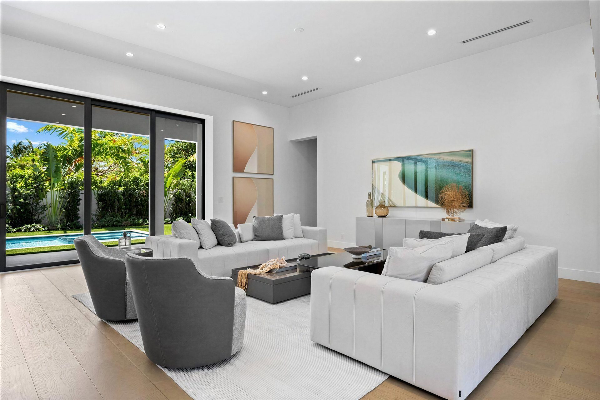 Bright staged living room with pool view
