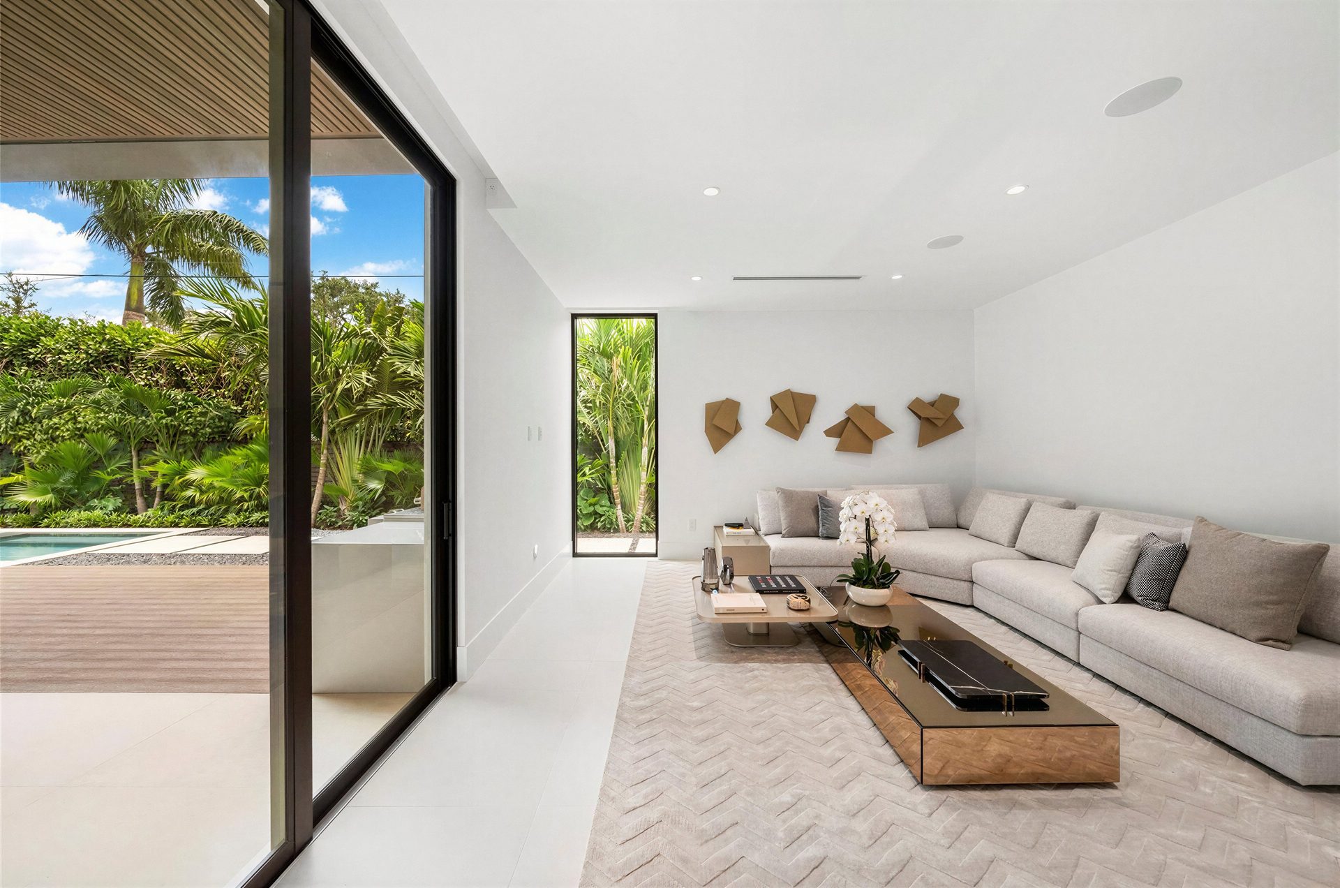 Staged great room opening to pool